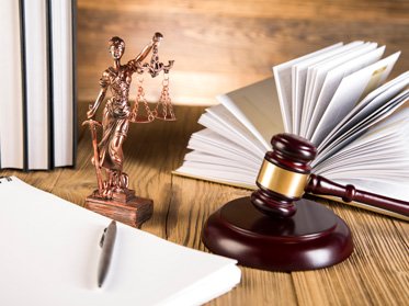 Lady of justice, a gavel, and books